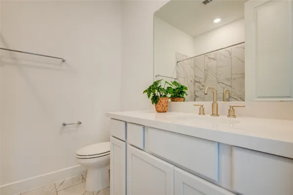a bathroom with a sink a mirror and a toilet