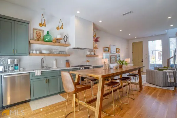 a kitchen with stainless steel appliances a stove a sink and a refrigerator