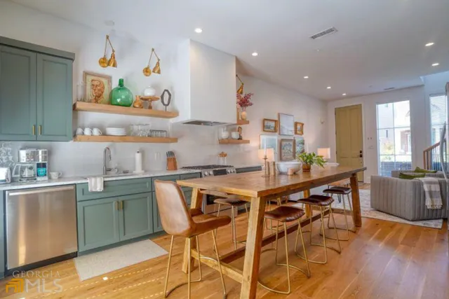 a kitchen with stainless steel appliances a stove a sink and a refrigerator