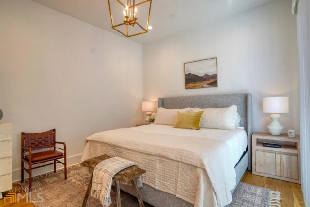 a bedroom with a bed and a chair