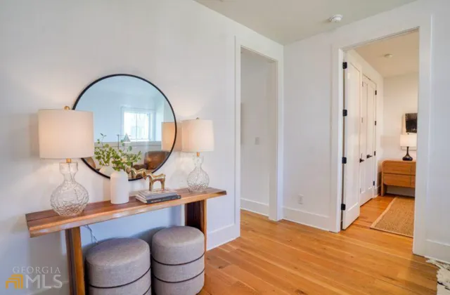 a living room with furniture and a mirror