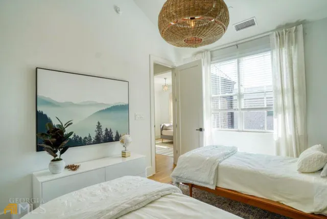 a bedroom with a bed and a mirror