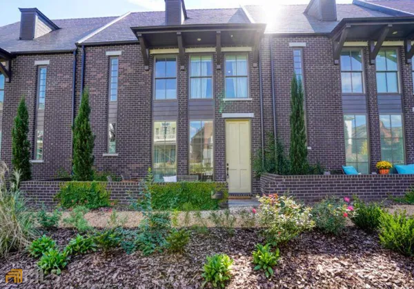a view of a brick building next to a yard