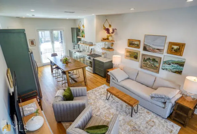 a living room with furniture and a wooden floor