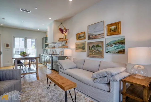 a living room with furniture and wooden floor