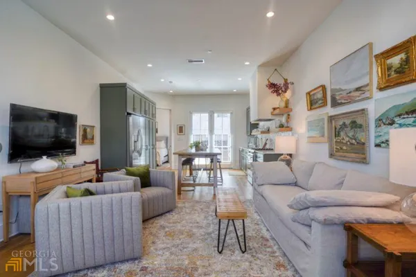 a living room with furniture and a flat screen tv