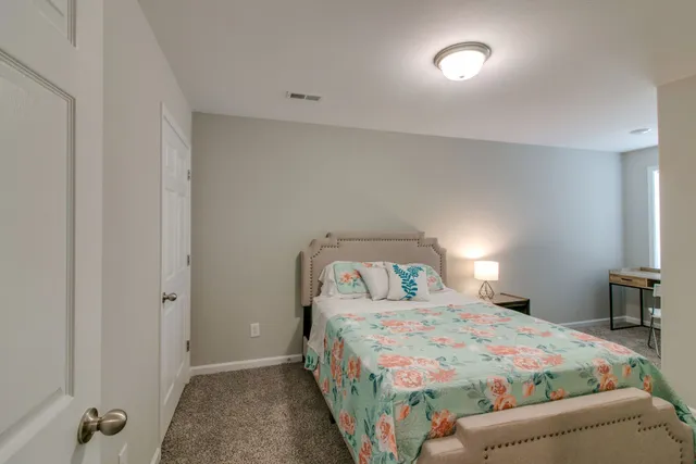 a bedroom with a bed and a lamp