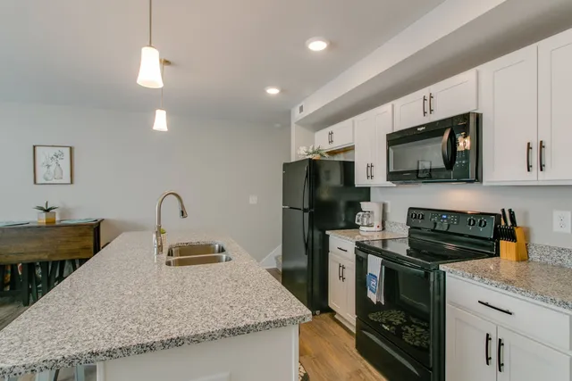 a kitchen with sink a microwave a stove and refrigerator