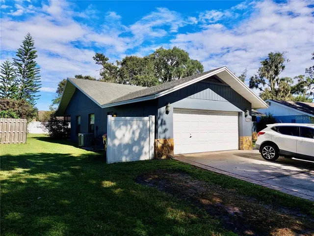 a house with green field in front of it