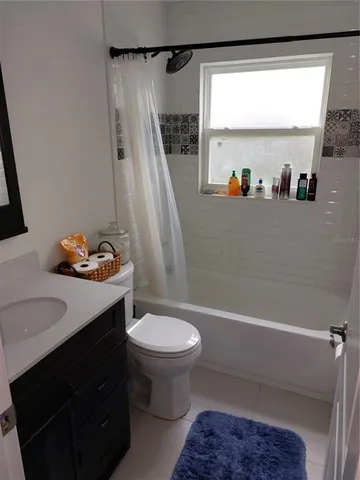 a bathroom with a sink a toilet and a shower