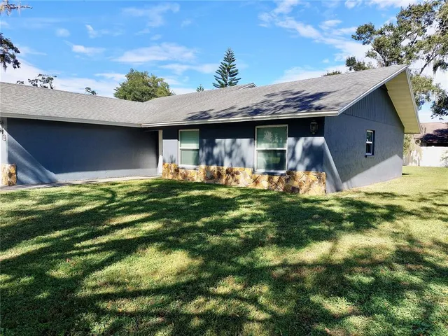a backyard of a house with table and chairs