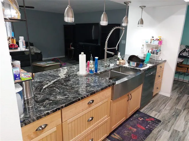 a kitchen with sink and cabinets