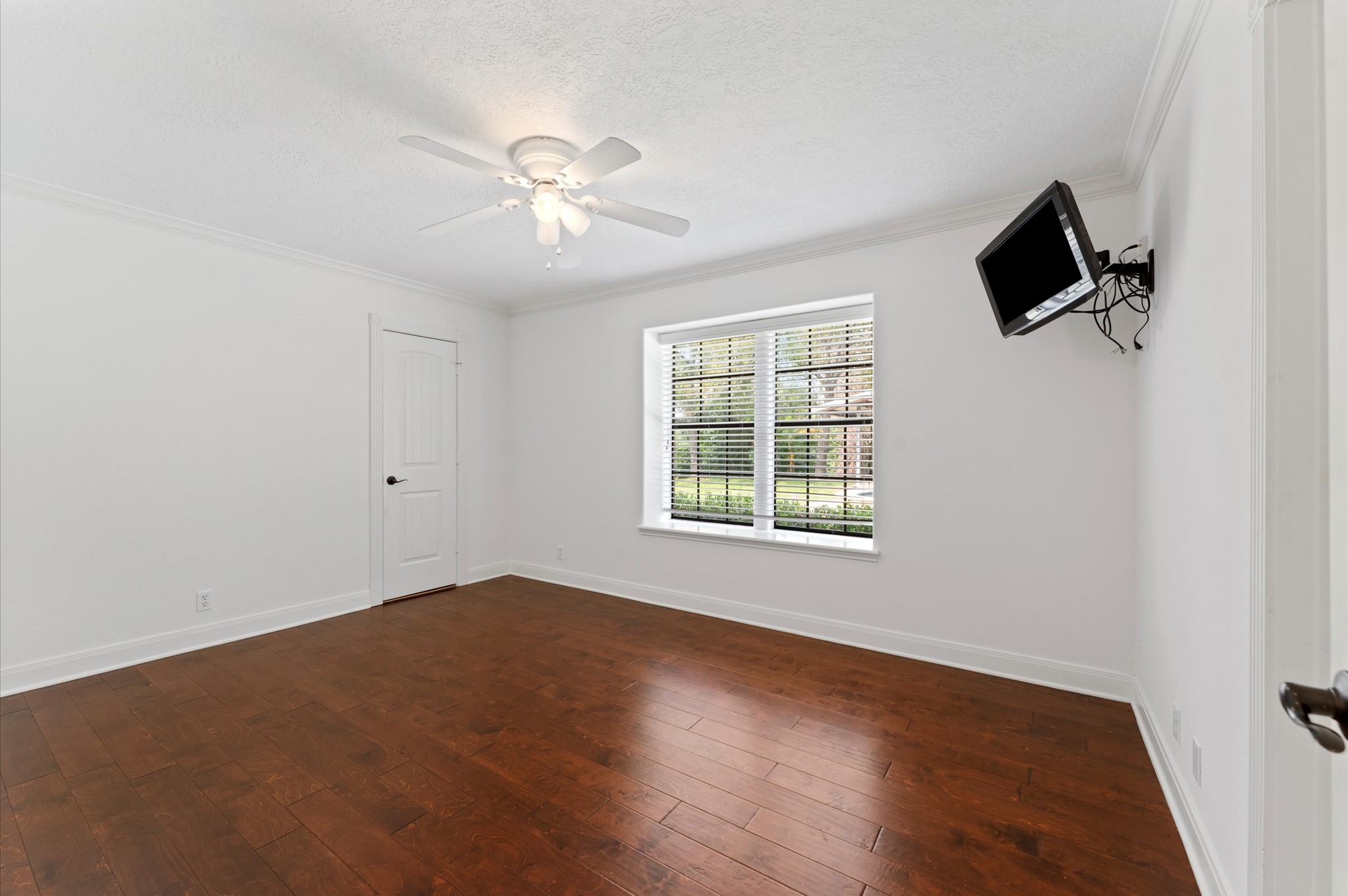 1101 Baker Road Rosenberg, TX 77471 - Photo 28 of 50 an empty room with wooden floor fan and windows