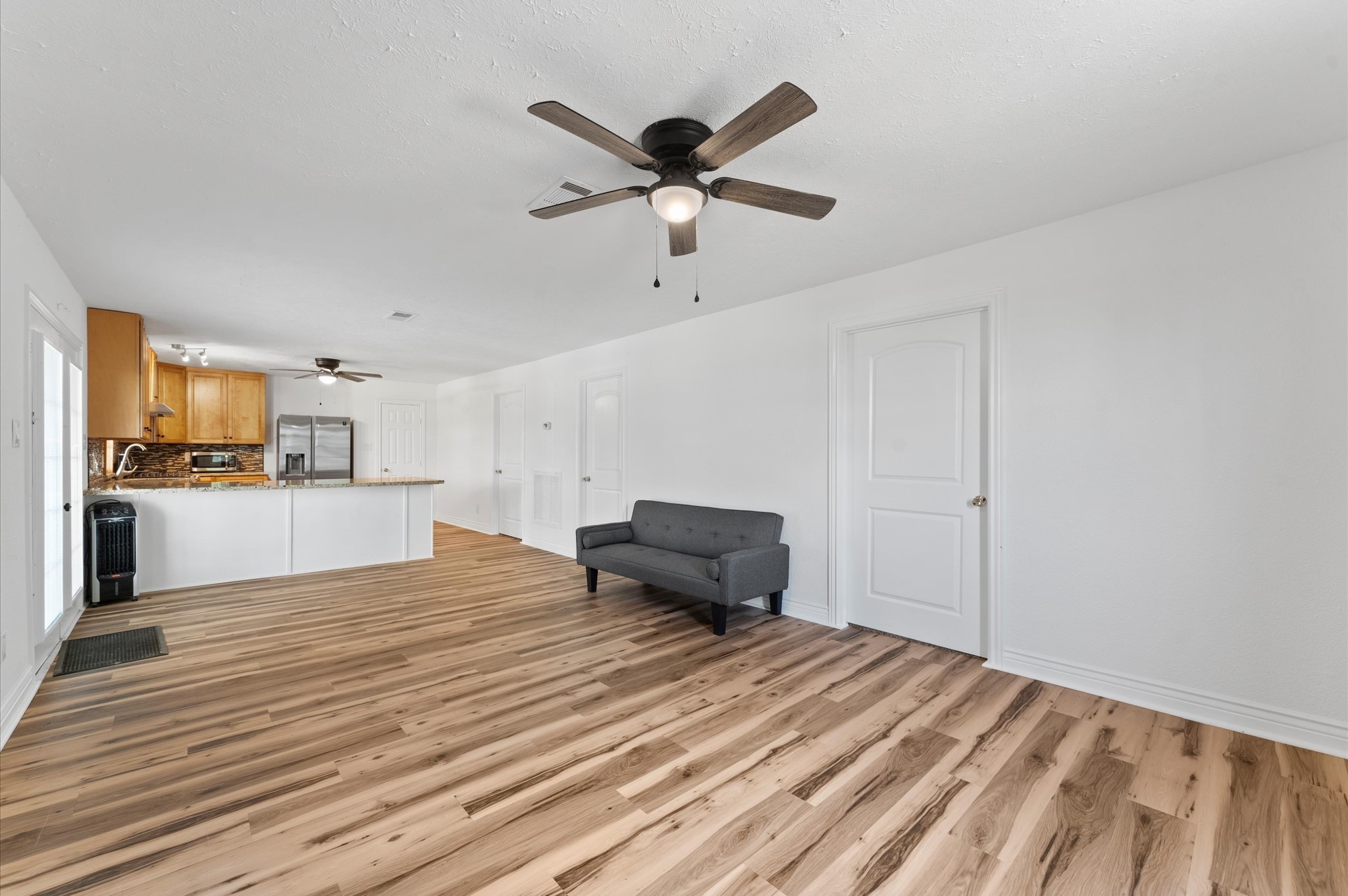1101 Baker Road Rosenberg, TX 77471 - Photo 38 of 50 a view of empty room with wooden floor and ceiling fan