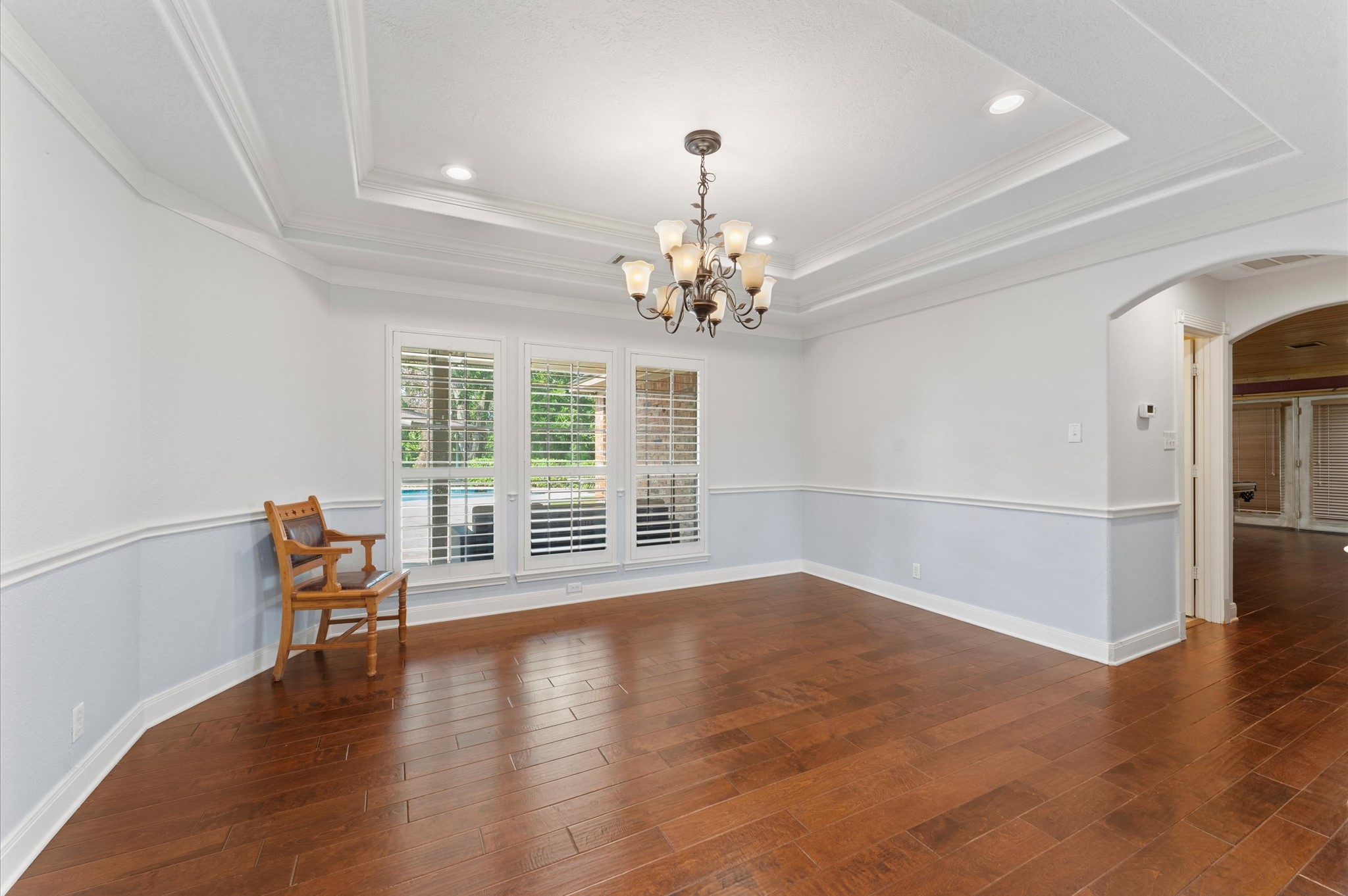 1101 Baker Road Rosenberg, TX 77471 - Photo 6 of 50 a view of a livingroom with wooden floor and a chandelier