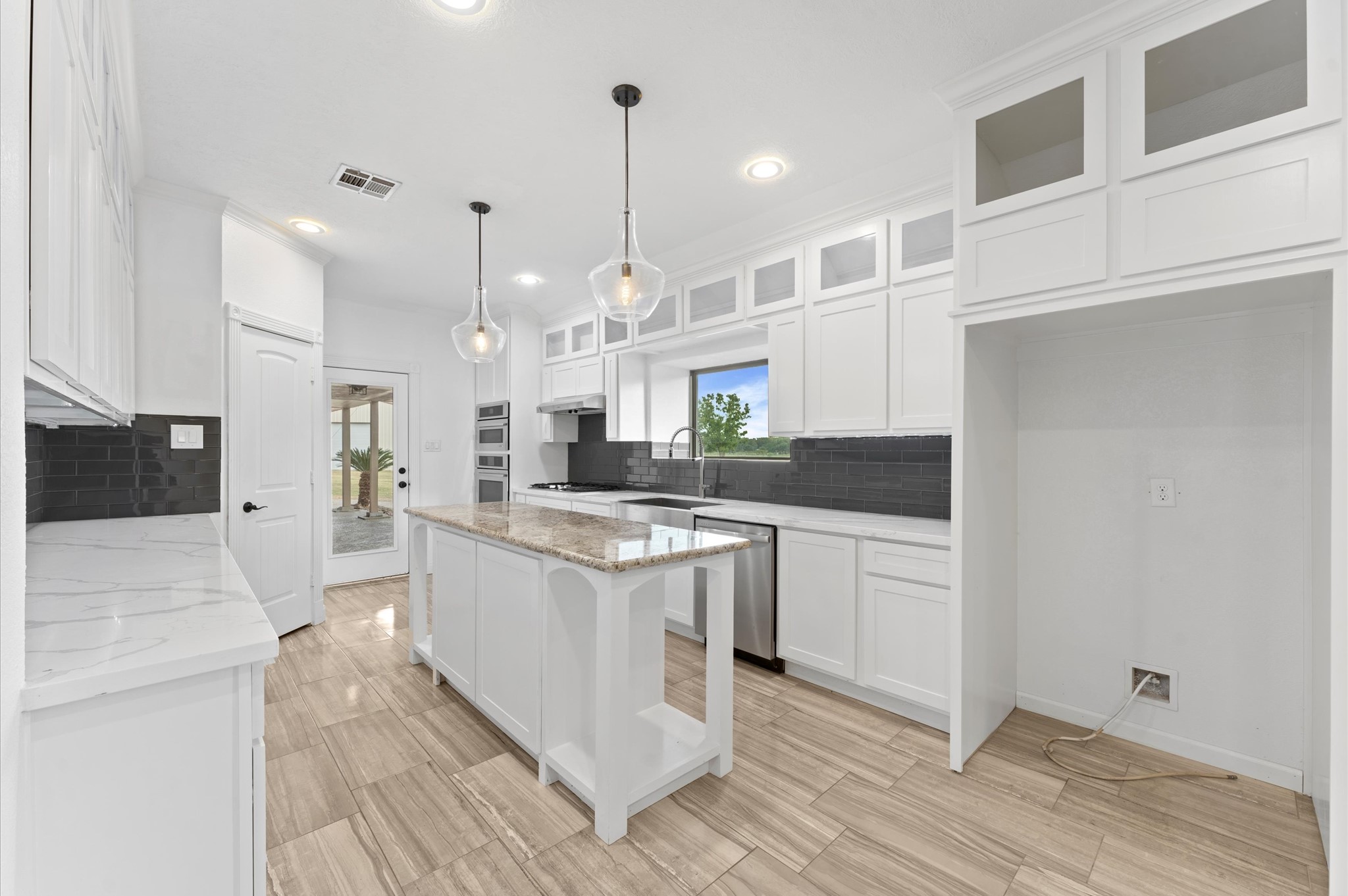 1101 Baker Road Rosenberg, TX 77471 - Photo 9 of 50 a kitchen with stainless steel appliances granite countertop a sink a stove and a refrigerator