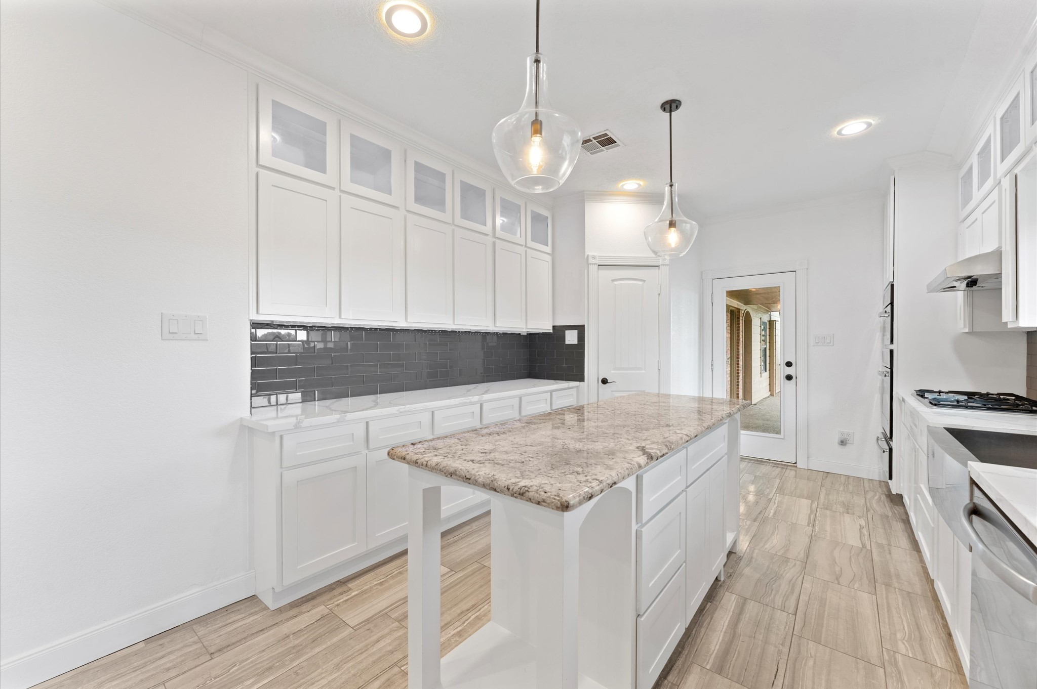 1101 Baker Road Rosenberg, TX 77471 - Photo 10 of 50 a kitchen with a sink a stove a refrigerator and white cabinets