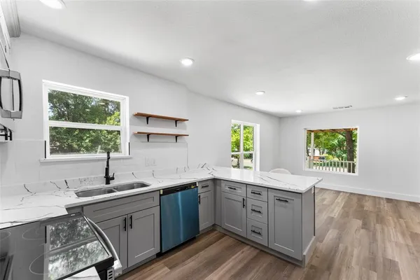 a kitchen with a sink window and cabinets
