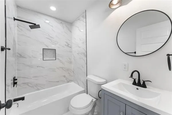 a bathroom with a sink a toilet and a mirror