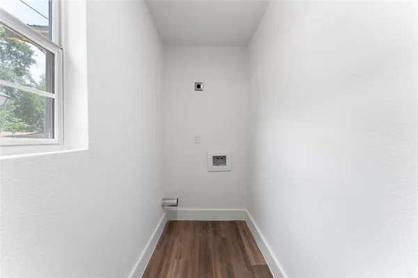 a view of a room with wooden floor and a window