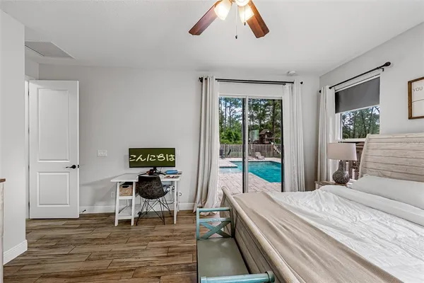 a bathroom with a tub a window and a flat screen tv