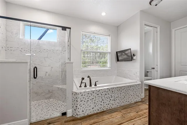 a bathroom with a sink a large mirror and a bathtub