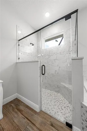 a bathroom with a bathtub a sink and a mirror