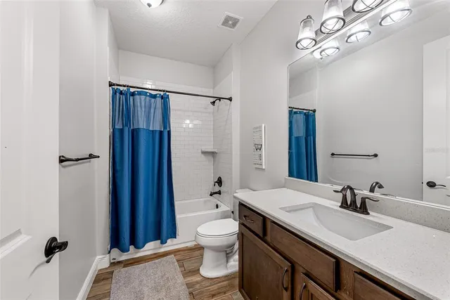 a view of open kitchen with a sink and a fireplace