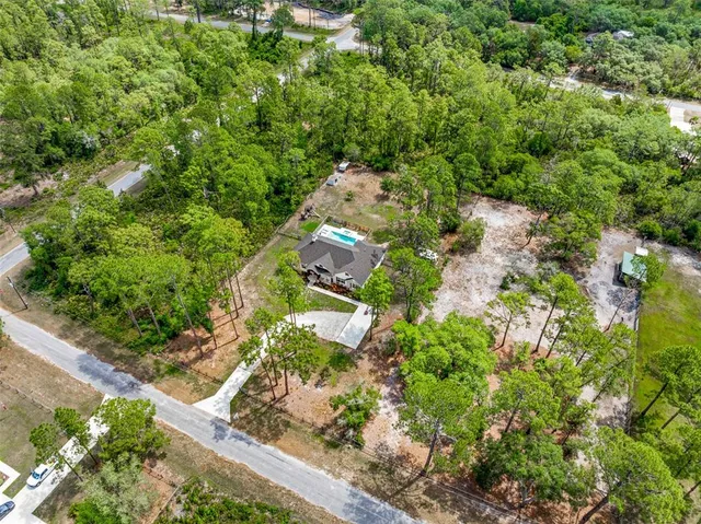 a view of a chairs and table in backyard