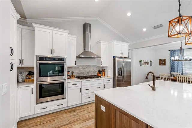 a kitchen with stainless steel appliances a stove sink and microwave
