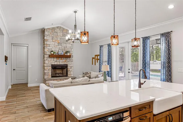 a room with kitchen island a wooden floor and living room view