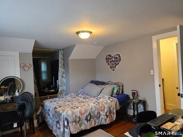 a bedroom with bed and a window