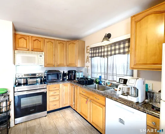 a kitchen with stainless steel appliances a stove sink and cabinets