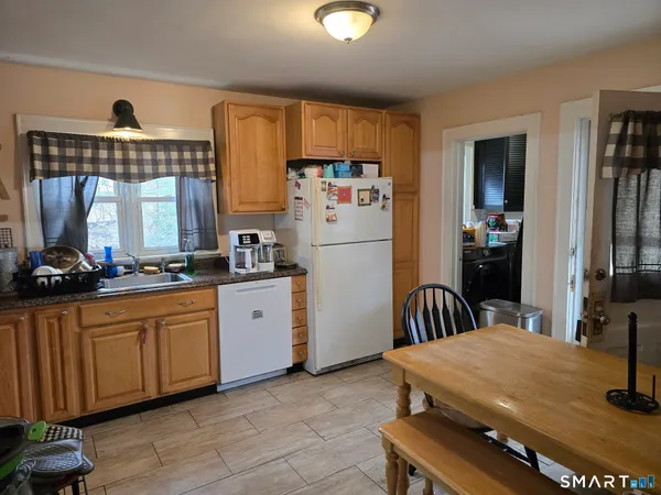 a kitchen with a refrigerator and a sink