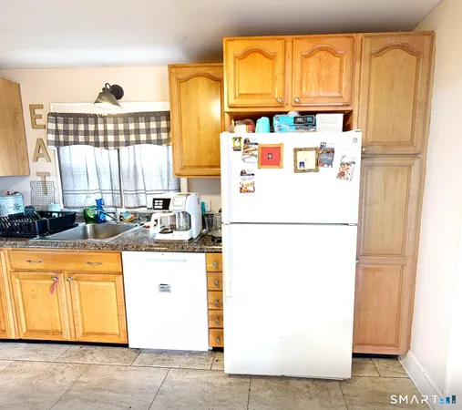 a white refrigerator freezer sitting inside of a kitchen