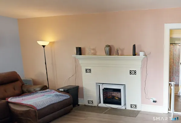 a bedroom with a bed and a fireplace