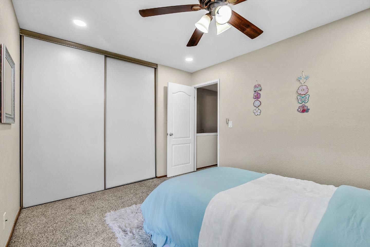 36913 Newark Boulevard, Unit A Newark, CA 94560 - Photo 13 of 20 a bedroom with a large bed and a chandelier