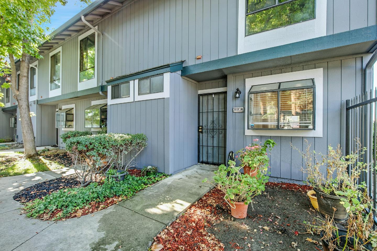 36913 Newark Boulevard, Unit A Newark, CA 94560 - Photo 18 of 20 a front view of a house with a yard