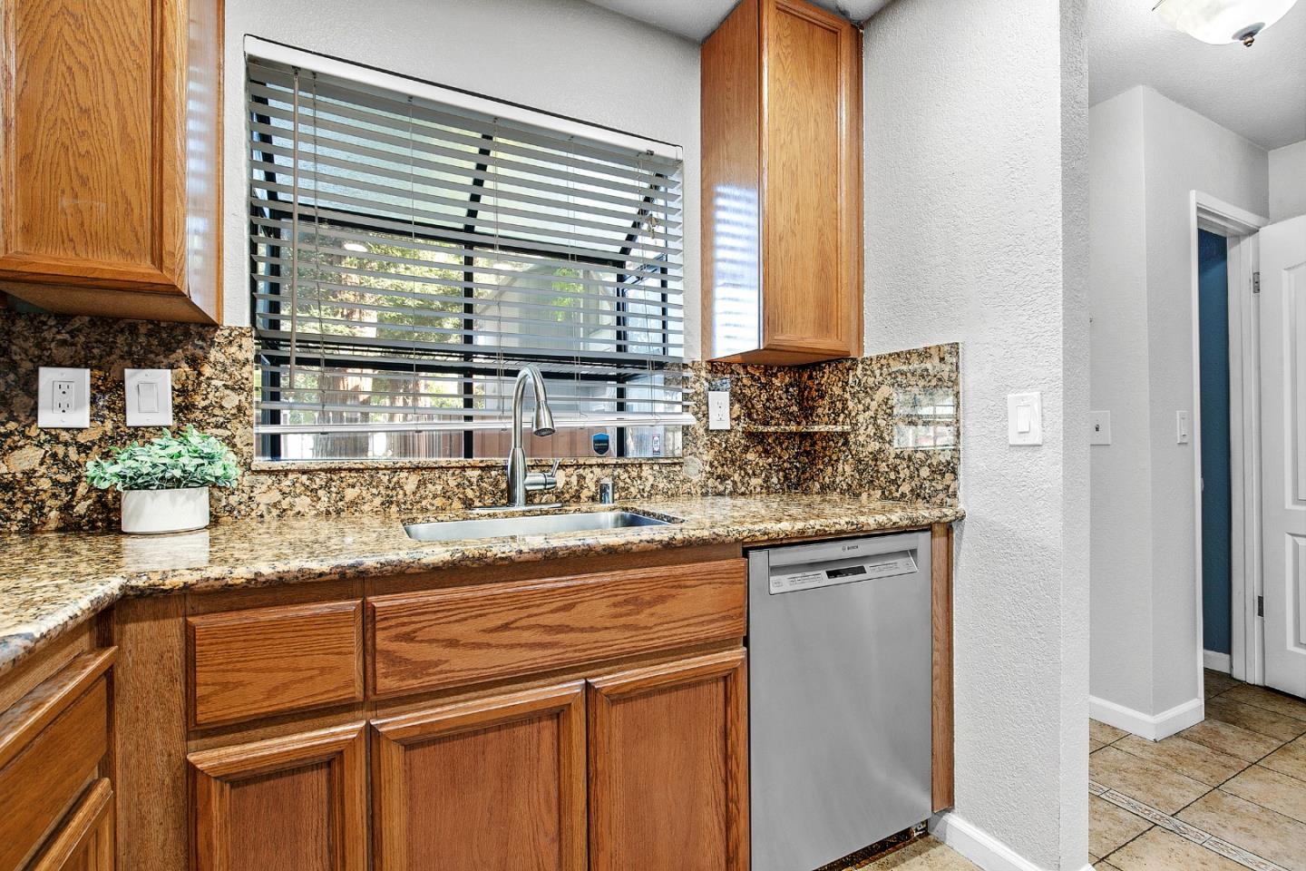 36913 Newark Boulevard, Unit A Newark, CA 94560 - Photo 6 of 20 a kitchen with granite countertop a sink and a window