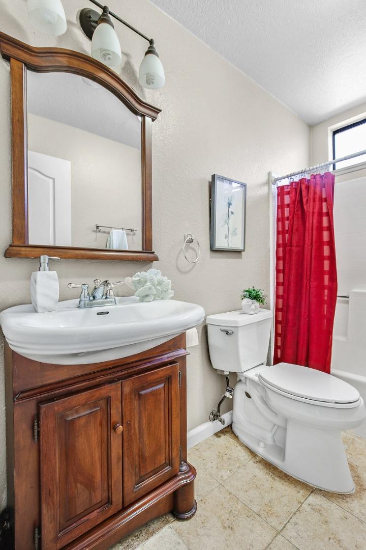 36913 Newark Boulevard, Unit A Newark, CA 94560 - Photo 9 of 20 a bathroom with a toilet a sink and mirror