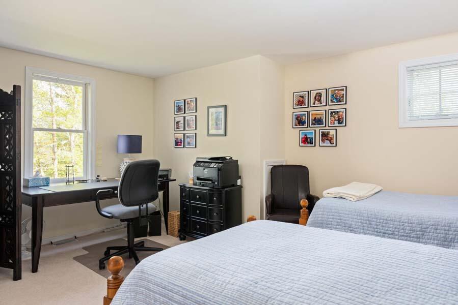 6 Wading Place Road Mashpee, MA 02649 - Photo 23 of 35 a bedroom with a bed and a desk