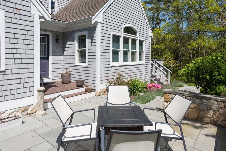 6 Wading Place Road Mashpee, MA 02649 - Photo 31 of 35 a view of a patio with table and chairs and potted plants