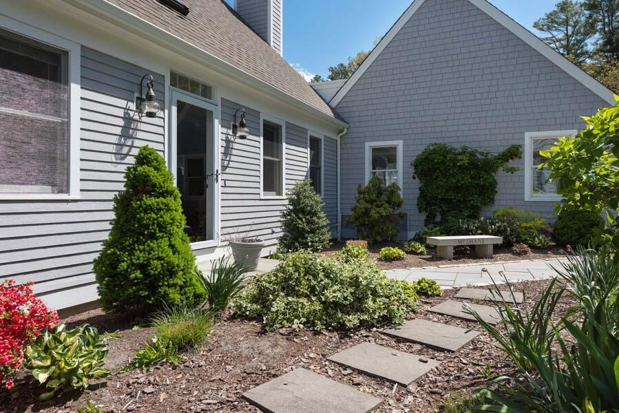 6 Wading Place Road Mashpee, MA 02649 - Photo 6 of 35 a view of a house with a yard and potted plants