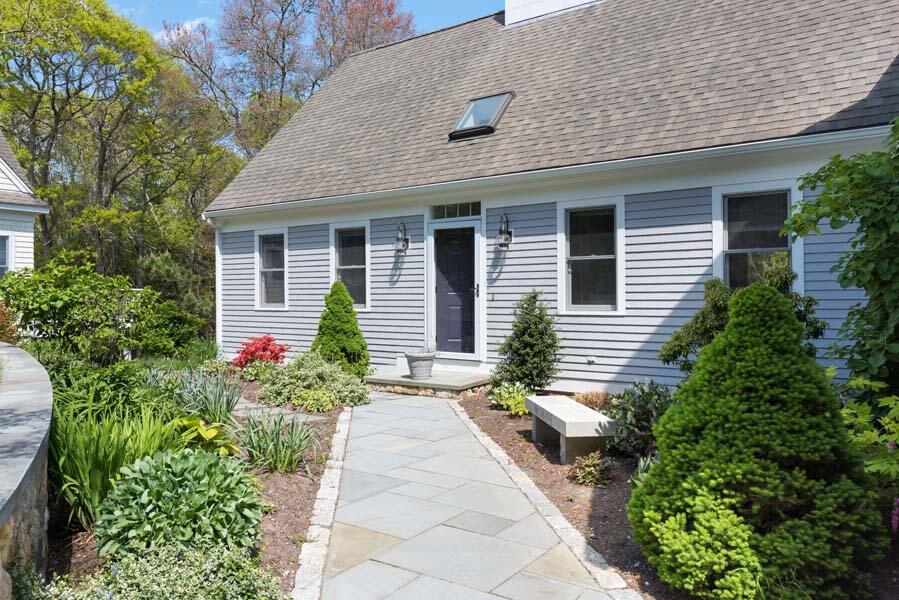 6 Wading Place Road Mashpee, MA 02649 - Photo 7 of 35 a front view of a house with a yard and potted plants