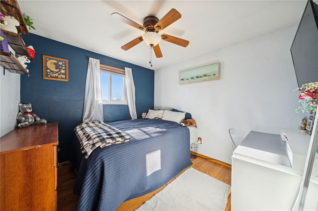 588 Carmelott Street Irwin, PA 15642 - Photo 15 of 33 a bedroom with a bed and a chandelier