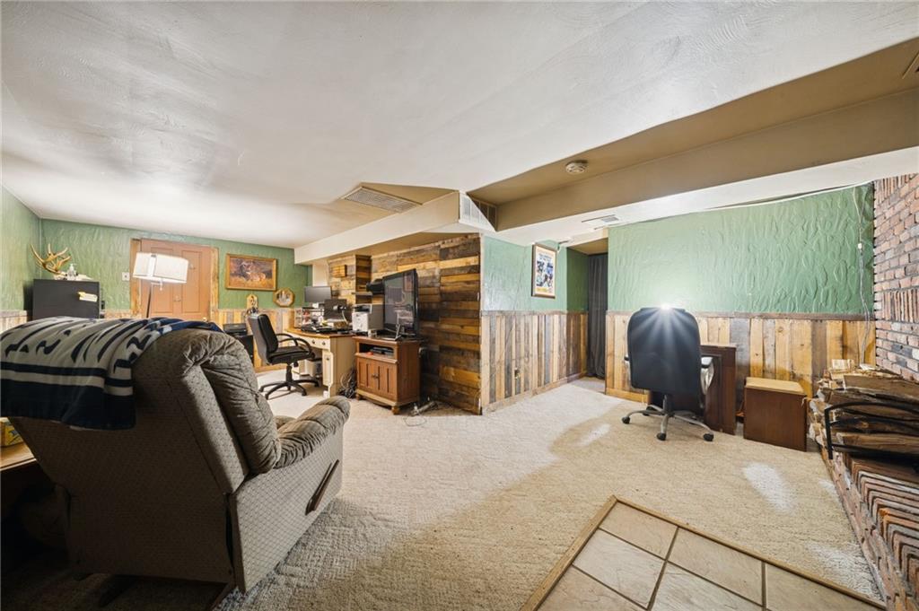 588 Carmelott Street Irwin, PA 15642 - Photo 22 of 33 a living room with furniture a flat screen tv and a refrigerator