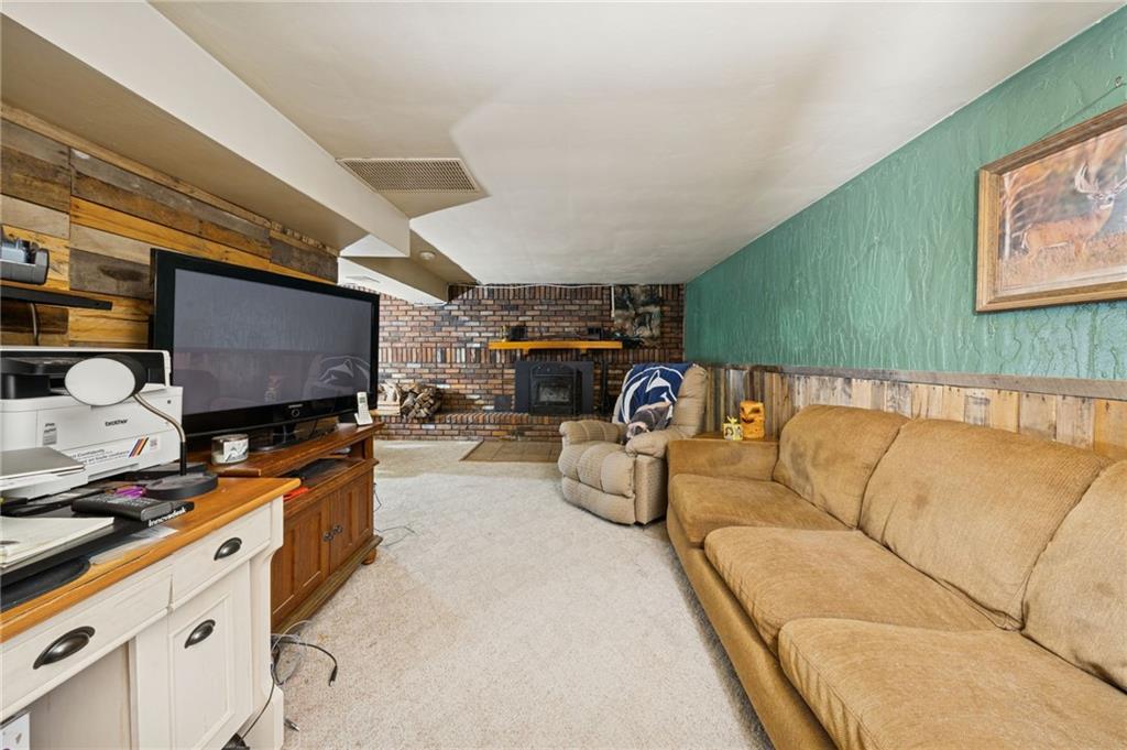 588 Carmelott Street Irwin, PA 15642 - Photo 25 of 33 a living room with furniture and a flat screen tv