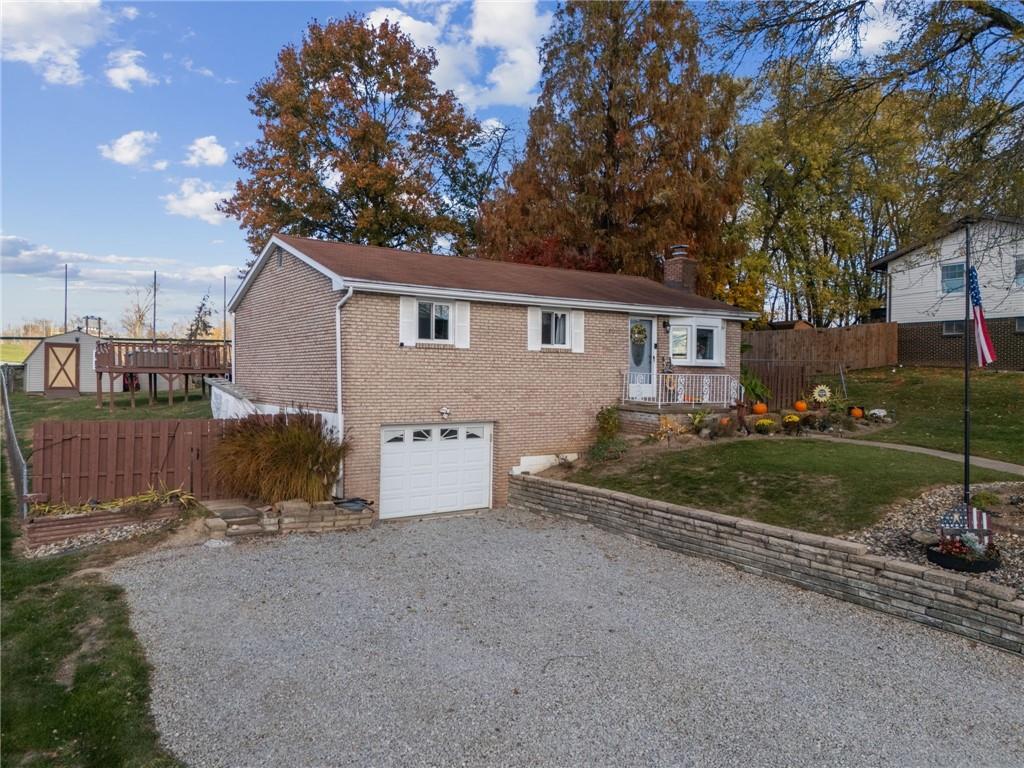 588 Carmelott Street Irwin, PA 15642 - Photo 26 of 33 a view of a house with a yard and large tree