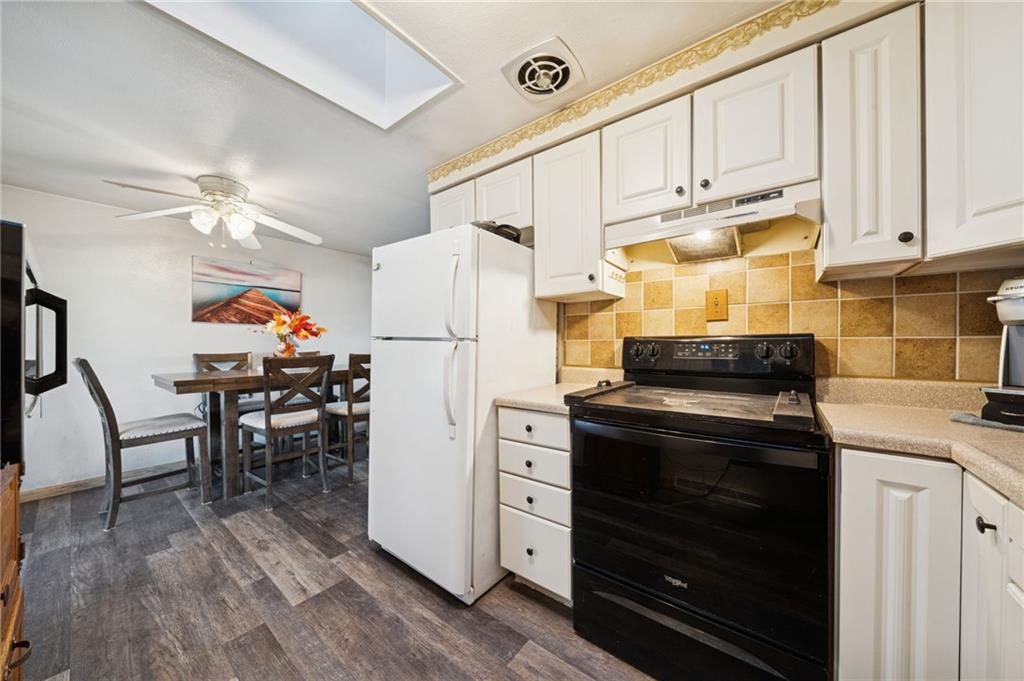588 Carmelott Street Irwin, PA 15642 - Photo 6 of 33 a kitchen with stainless steel appliances a stove a refrigerator cabinets and wooden floor