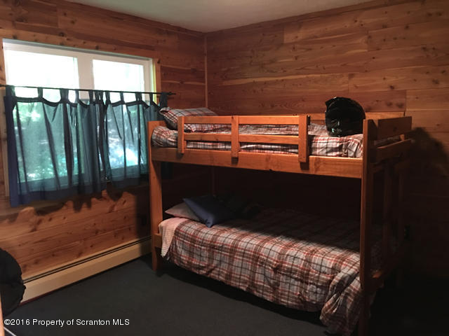 1270 Wildenberg Road Union Dale, PA 18470 - Photo 10 of 17 a bed sitting in a bedroom next to a window